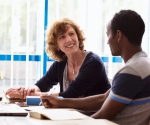 A dyslexia assessor running through a report with a parent