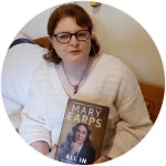A headshot of Paula holding her copy of All In by Mary Earps